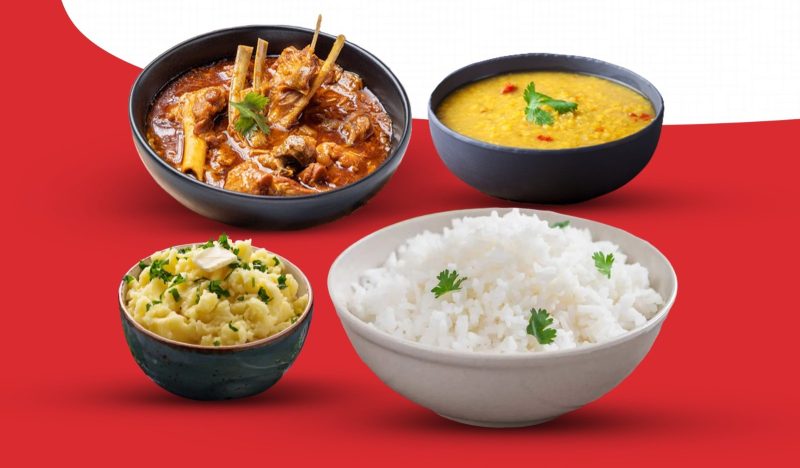 A flavorful combo of goat curry with plain rice or naan, paired with creamy daal and spiced vorta.