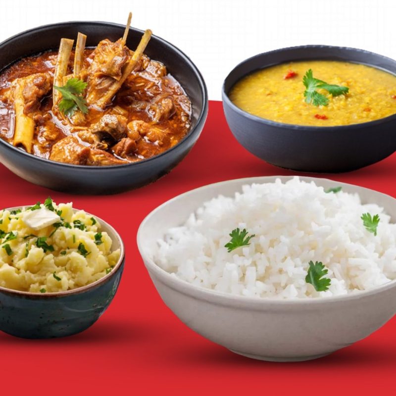 A flavorful combo of goat curry with plain rice or naan, paired with creamy daal and spiced vorta.